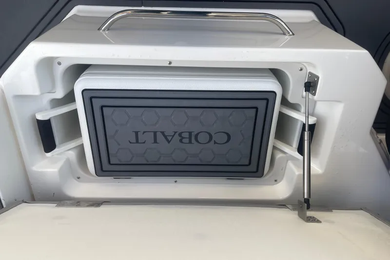 Slide: The Image of 2023 Cobalt R6 Surf boat storage compartment with integrated cooler. - 31