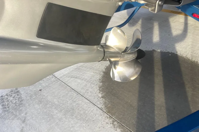 Slide: The Image of 2023 Cobalt R6 Surf boat propeller on concrete surface, showcasing sleek design. - 5