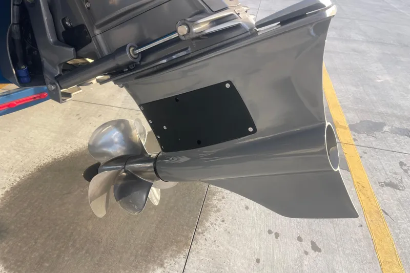 Slide: The Image of 2023 Cobalt R6 Surf boat propeller and outdrive on concrete surface. - 6