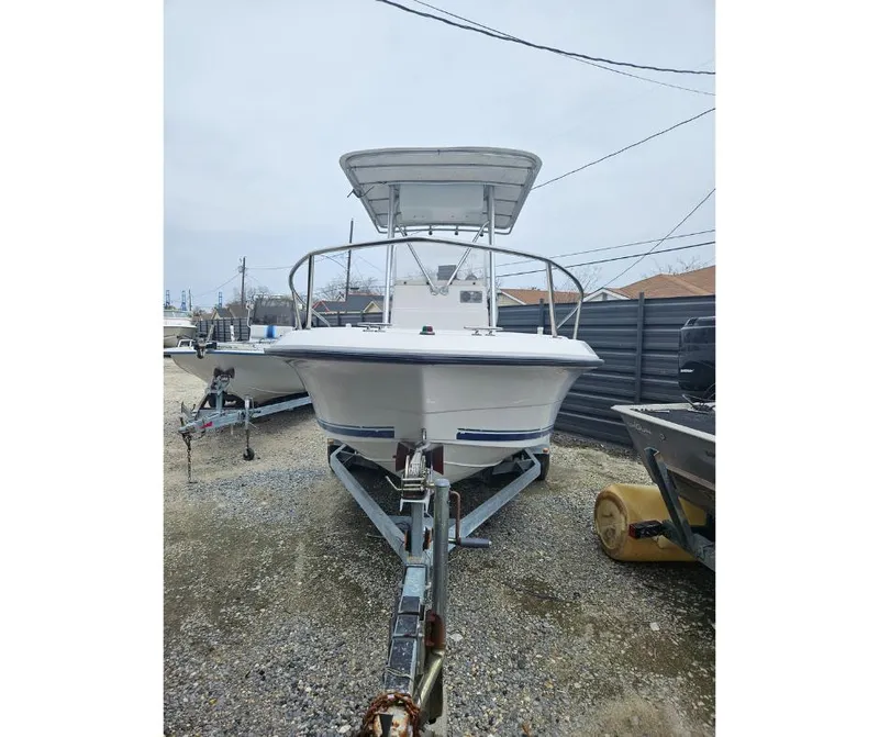 Slide: The Image of 1997 Stratos 1870 CC boat on a trailer in a yard. - 1