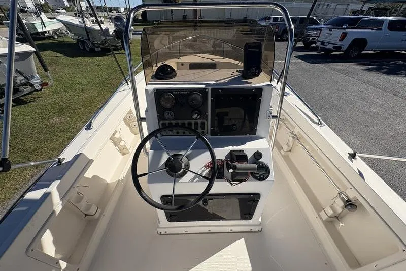 Slide: The Image of 2002 Key West 1900 Center Console boat interior with steering wheel and dashboard controls. - 12