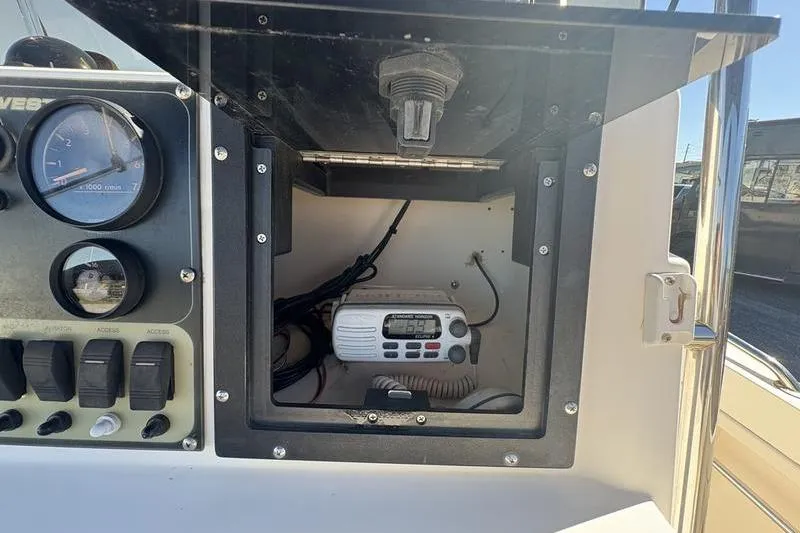 Slide: The Image of 2002 Key West 1900 Center Console dashboard with radio and gauges. - 17