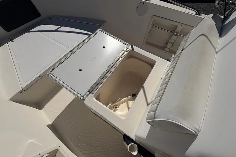 Slide: The Image of 2002 Key West 1900 Center Console boat interior with open storage compartment. - 24