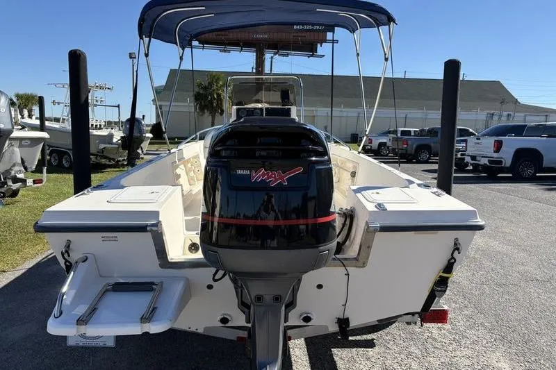 Slide: The Image of 2002 Key West 1900 Center Console boat with Yamaha VMAX engine, parked outdoors. - 3