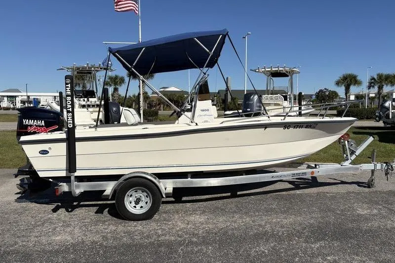 Slide: The Image of 2002 Key West 1900 Center Console boat on trailer with Yamaha engine and blue canopy. - 5