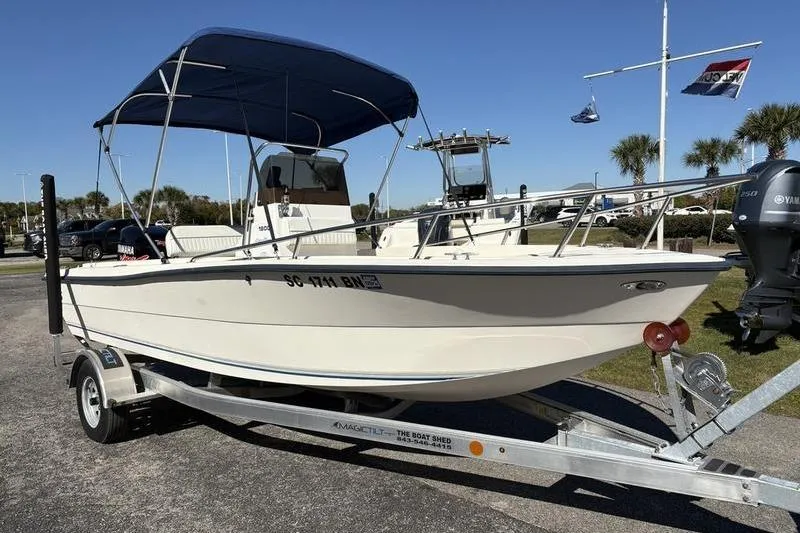 Slide: The Image of 2002 Key West 1900 Center Console boat on trailer with blue canopy. - 6