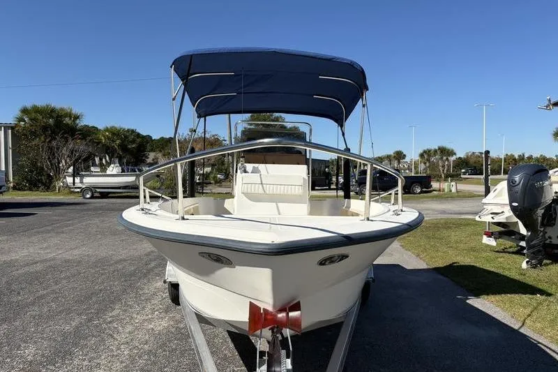 Slide: The Image of 2002 Key West 1900 Center Console boat with blue canopy on trailer. - 7