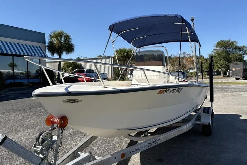 Slide: The Image of 2002 Key West 1900 Center Console boat on trailer with blue canopy. - 8