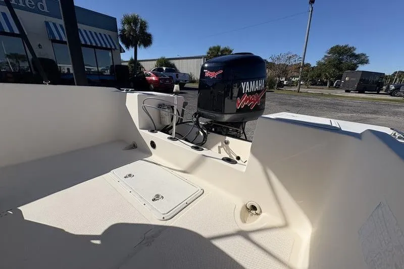 Slide: The Image of 2002 Key West 1900 Center Console boat with Yamaha outboard motor in a parking lot. - 9