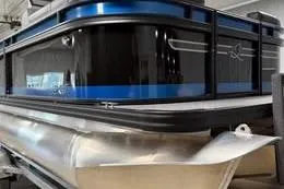 Slide: The Image of 2025 Qwest Lanai E-Class Tripletoon pontoon boat with sleek design and blue accents. - 1