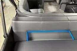 Slide: The Image of Interior of 2025 Qwest Lanai E-Class Tripletoon pontoon boat with gray seating. - 10