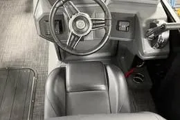 Slide: The Image of 2025 Qwest Lanai E-Class Tripletoon steering wheel and dashboard interior. - 14