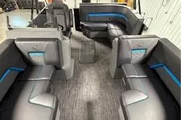 Slide: The Image of Interior of 2025 Qwest Lanai E-Class Tripletoon with modern seating and sleek design. - 15