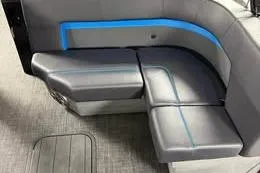 Slide: The Image of 2025 Qwest Lanai E-Class Tripletoon boat interior with sleek gray seating and blue accent lighting. - 7