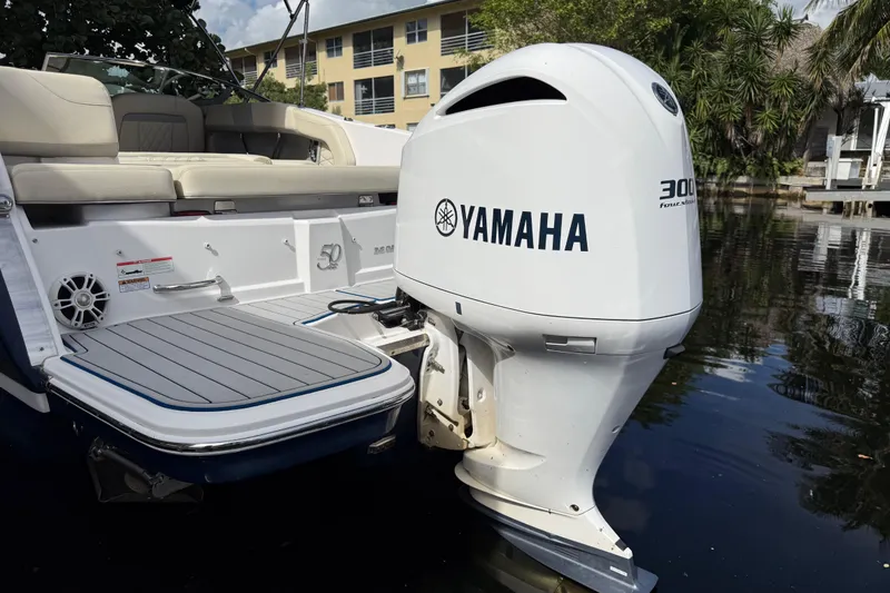 Slide: The Image of 2021 Regal 26 OBX boat with Yamaha 300 outboard motor on calm water. - 13