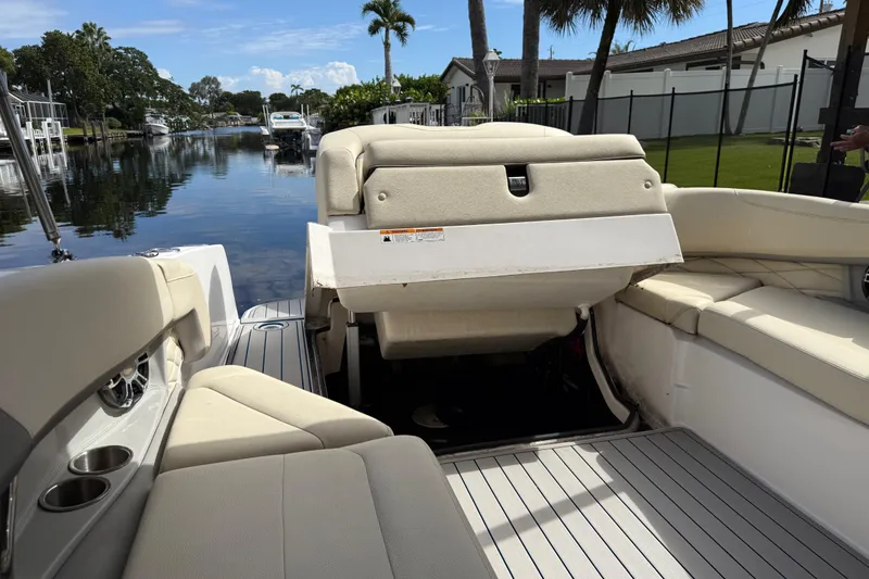 Slide: The Image of 2021 Regal 26 OBX boat interior with beige seating and canal view. - 14