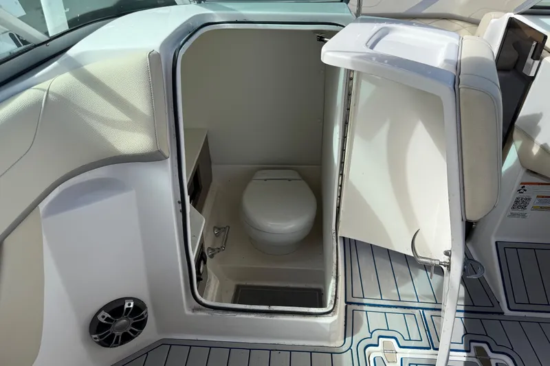 Slide: The Image of 2021 Regal 26 OBX boat interior with compact marine toilet. - 6