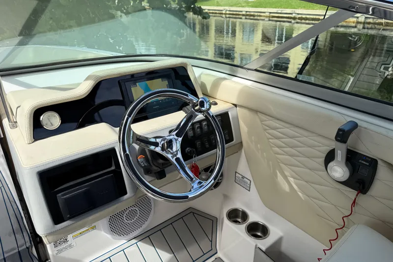 Slide: The Image of Interior view of 2021 Regal 26 OBX boat dashboard with steering wheel and controls. - 9
