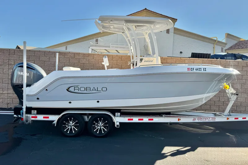 The Image of 2022 Robalo R222 Center Console boat on trailer, side view. - 0