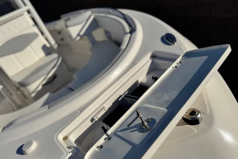 Slide: The Image of 2022 Robalo R222 Center Console boat interior with open storage compartment. - 10