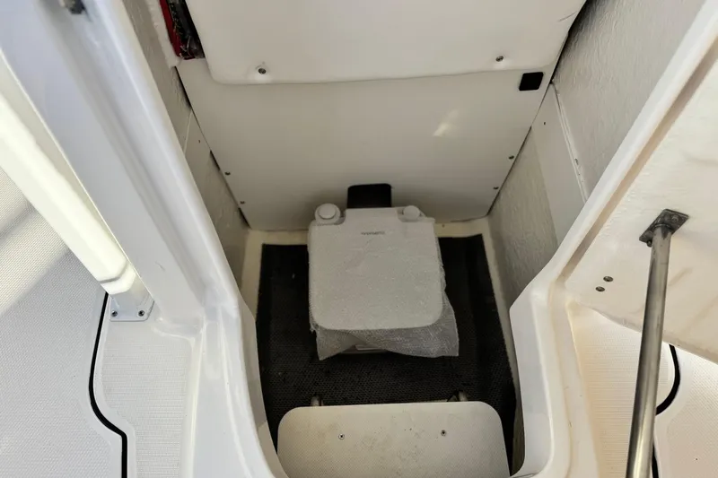 Slide: The Image of 2022 Robalo R222 Center Console interior storage compartment with white and black accents. - 17