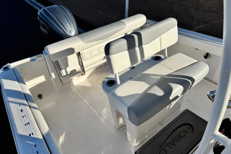 Slide: The Image of 2022 Robalo R222 Center Console boat interior with seating and engine view. - 21
