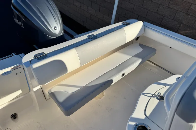 Slide: The Image of 2022 Robalo R222 Center Console boat with Yamaha engine and cushioned seating. - 22