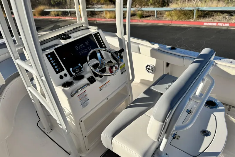 Slide: The Image of 2022 Robalo R222 Center Console boat interior with steering wheel and control panel. - 30