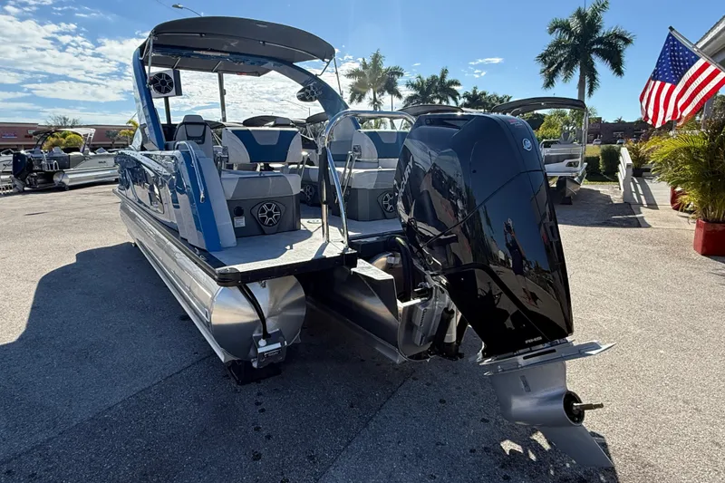 Slide: The Image of 2026 Avalon 2585 Excalibur Tri-toon with Mercury 400hp V-10 engine, parked outdoors. - 10