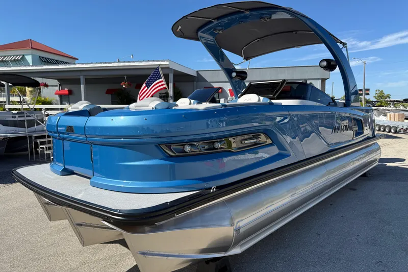 Slide: The Image of 2026 Avalon 2585 Excalibur Tri-toon boat with Mercury 400hp V-10 engine, blue exterior. - 2
