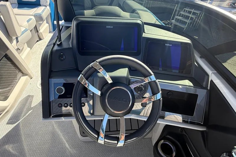 Slide: The Image of 2026 Avalon 2585 Excalibur boat dashboard with steering wheel and digital displays. - 26