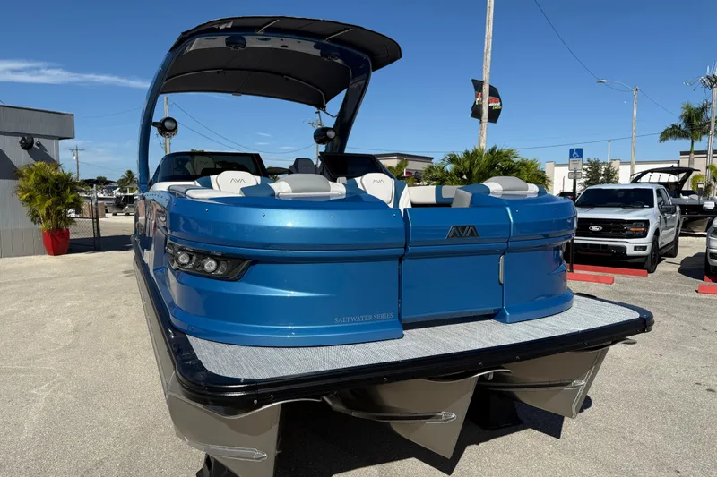 Slide: The Image of 2026 Avalon 2585 Excalibur Tri-toon boat, blue, parked outdoors, featuring Mercury 400hp V-10 engine. - 5