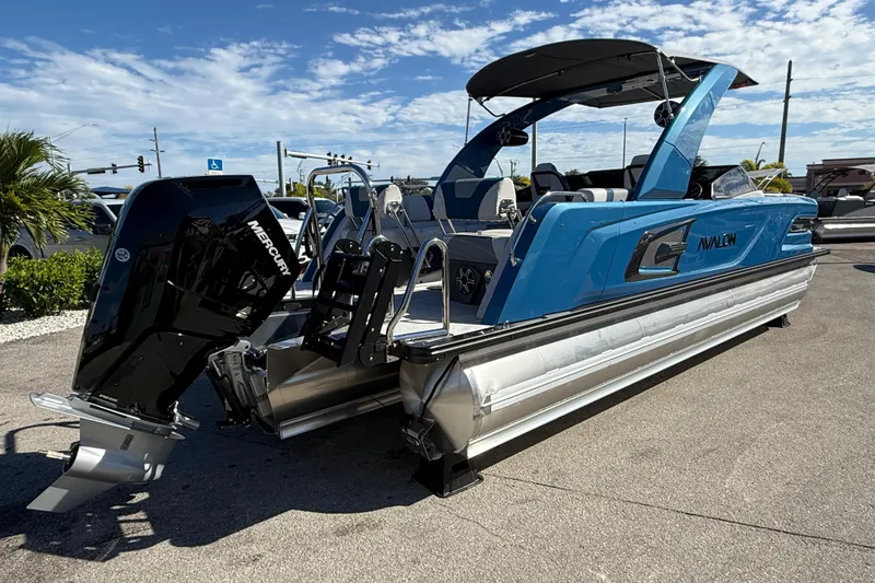 Slide: The Image of 2026 Avalon 2585 Excalibur Tri-toon boat with Mercury 400hp V-10 engine, blue exterior. - 7