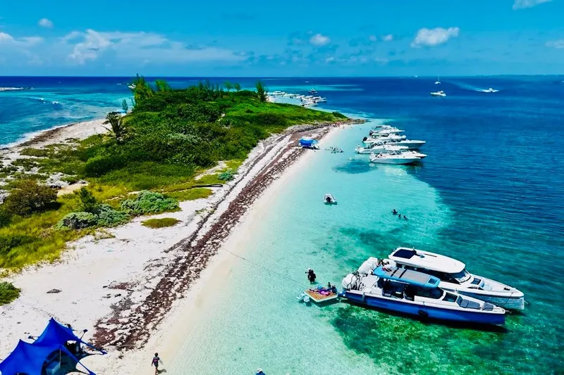 The Image of Coastal scene with 2021 Axopar 37 Sun Top boats anchored on a tropical beach. - 0