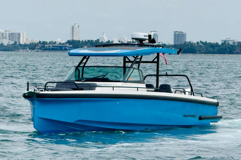 Slide: The Image of 2021 Axopar 37 Sun Top boat cruising on water with city skyline in background. - 11