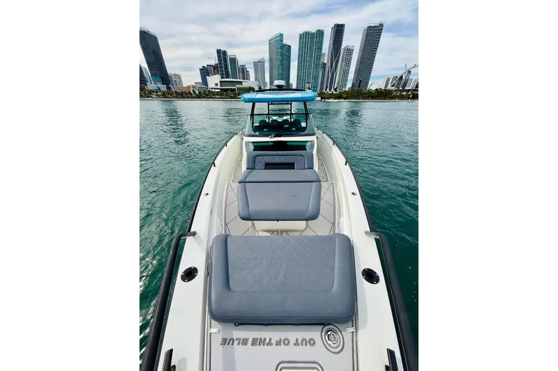 Slide: The Image of 2021 Axopar 37 Sun Top boat with city skyline in the background. - 17