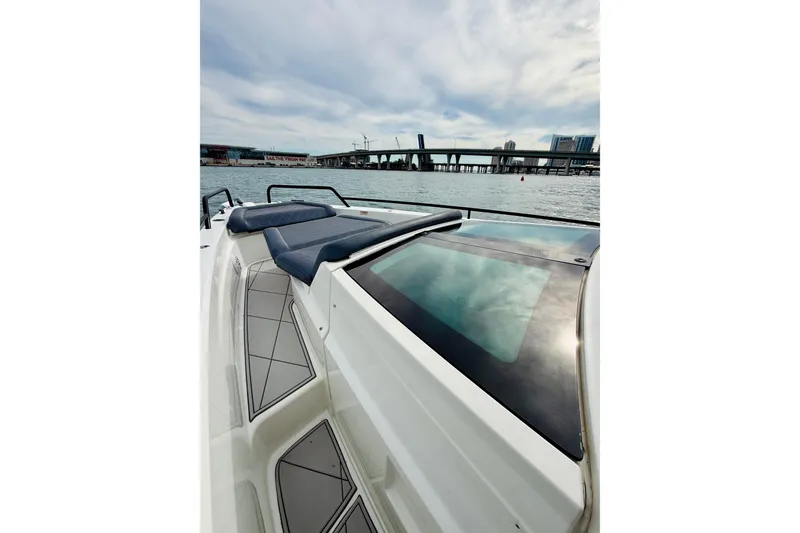 Slide: The Image of 2021 Axopar 37 Sun Top boat with sleek design on calm waters. - 19