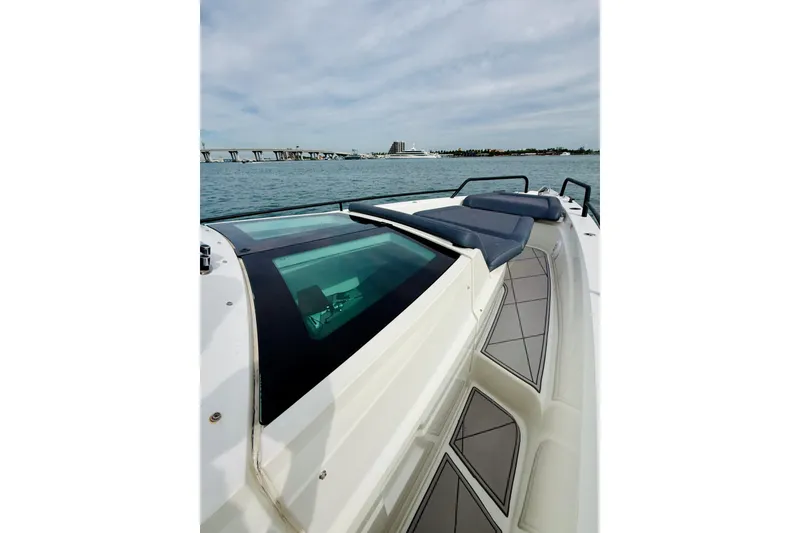 Slide: The Image of 2021 Axopar 37 Sun Top boat with sleek design on open water. - 20