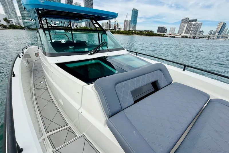 Slide: The Image of 2021 Axopar 37 Sun Top boat with city skyline in background. - 21
