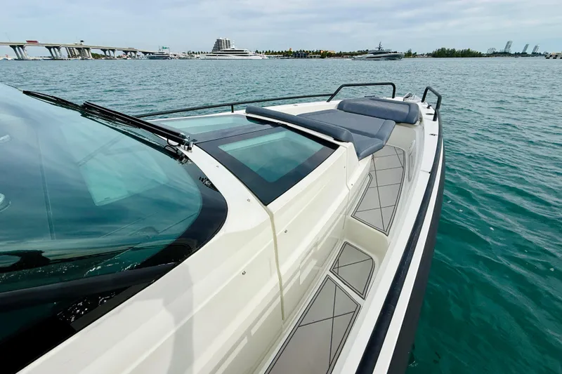 Slide: The Image of 2021 Axopar 37 Sun Top boat on water, featuring sleek design and spacious deck. - 25