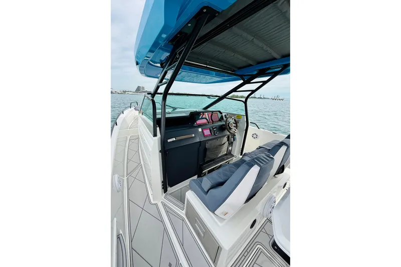 Slide: The Image of 2021 Axopar 37 Sun Top boat interior with modern helm and seating on open water. - 31