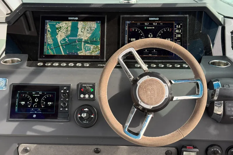 Slide: The Image of Steering console of 2021 Axopar 37 Sun Top with navigation displays and controls. - 36