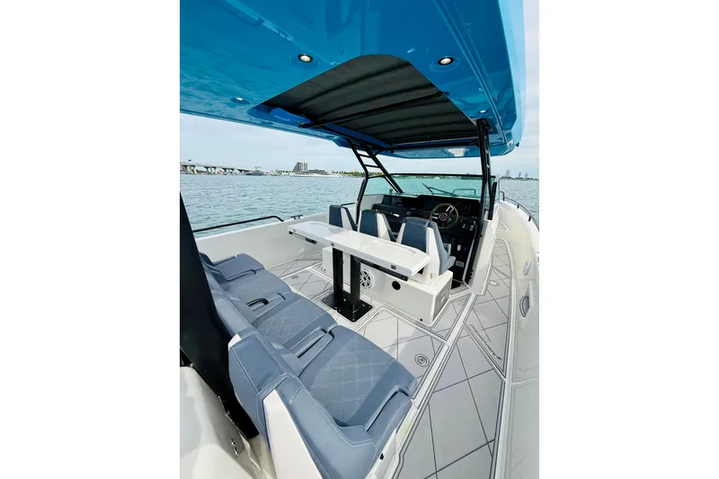 Slide: The Image of 2021 Axopar 37 Sun Top boat interior with seating and helm, overlooking water. - 38