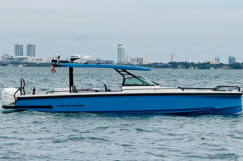 Slide: The Image of 2021 Axopar 37 Sun Top boat on water with city skyline in background. - 4