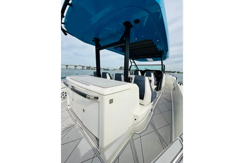 Slide: The Image of 2021 Axopar 37 Sun Top boat with sleek design and spacious seating on the water. - 44