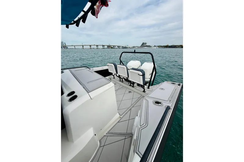 Slide: The Image of 2021 Axopar 37 Sun Top boat with sleek deck design on open water. - 49