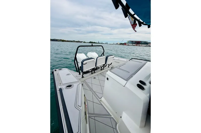 Slide: The Image of 2021 Axopar 37 Sun Top boat on water, featuring sleek deck design and seating. - 50