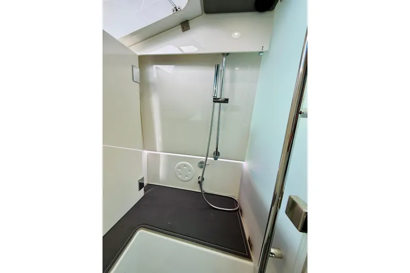 Slide: The Image of 2021 Axopar 37 Sun Top boat shower interior with modern fixtures and sleek design. - 54