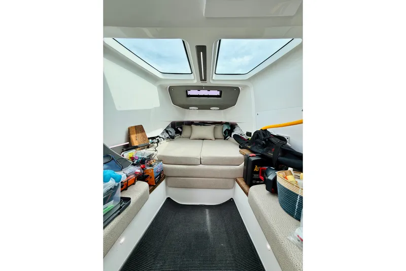 Slide: The Image of Interior of 2021 Axopar 37 Sun Top boat with cozy seating and storage. - 55