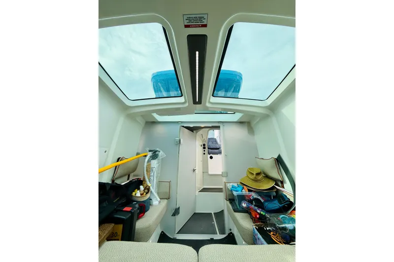 Slide: The Image of Interior view of 2021 Axopar 37 Sun Top boat with skylights and seating area. - 56